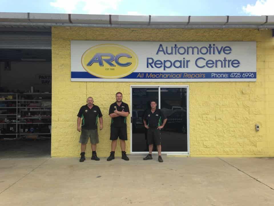 Three Men Are Standing In Front Of An Automotive Repair Centre — Automotive Repair Centre In Garbutt, QLD