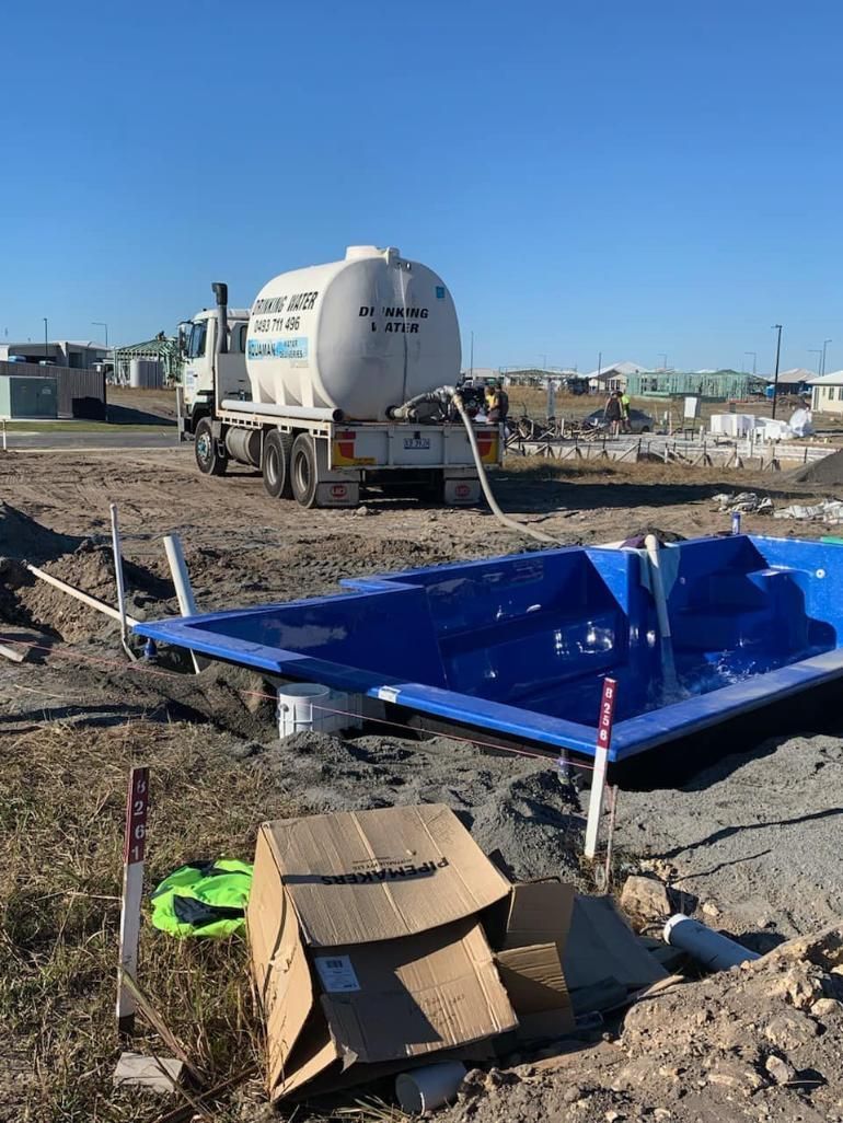 A Concrete Truck Is Pouring Concrete Into A Swimming Pool — Aquaman Watàr Deliveries In Mooloolah Valley, QLD