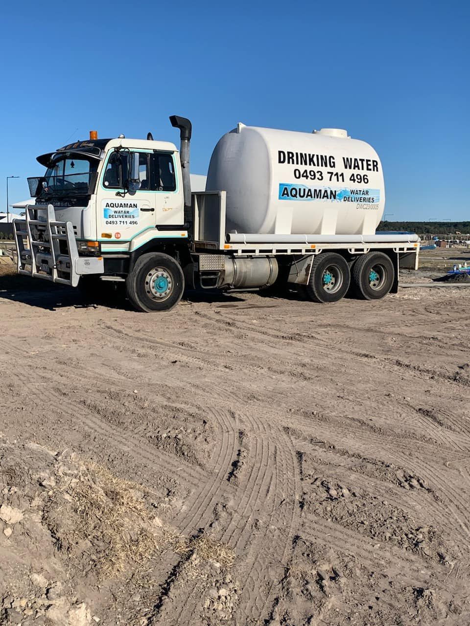 A White Truck Is Parked In A Dirt Field — Aquaman Watàr Deliveries In Mooloolah Valley, QLD