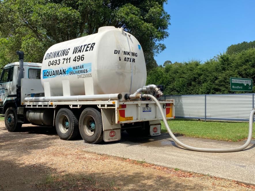 A Water Truck Is Being Filled With Water From A Hose — Aquaman Watàr Deliveries In Sunshine Coast Hinterland, QLD