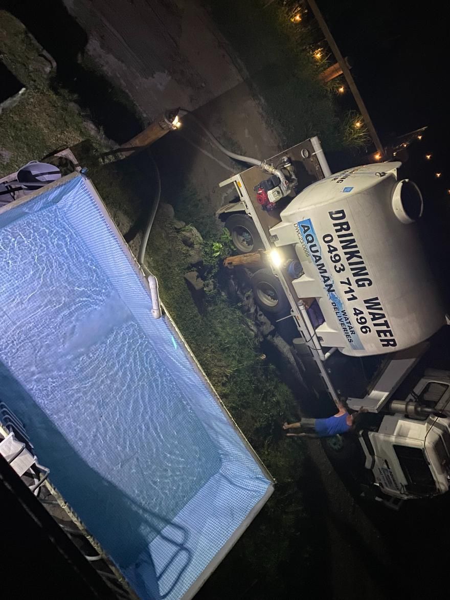 A Large Tank Of Drinking Water Is Sitting Next To A Swimming Pool — Aquaman Watàr Deliveries In Beerwah, QLD