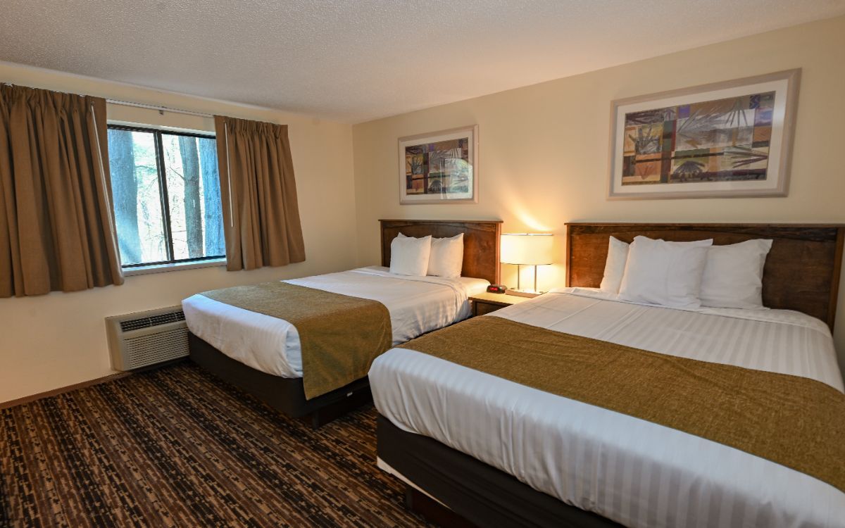 A hotel room with a king size bed and a flat screen tv.