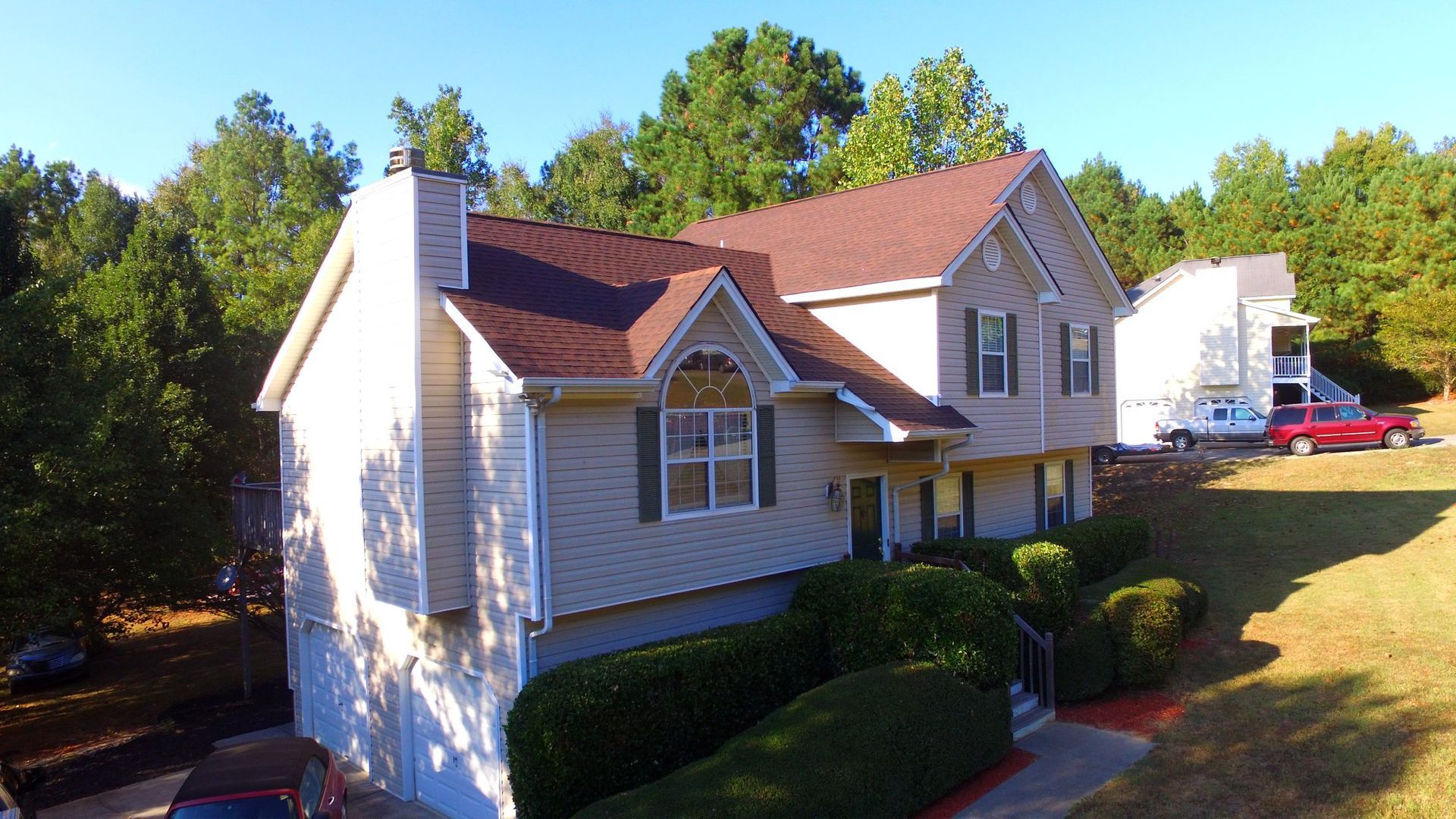 An aerial view of a house with a red roof