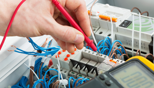 Electrician Using Electronic Tester
