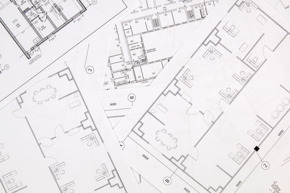 Architectural blueprints, detailed floor plans, and building layouts, on white paper.