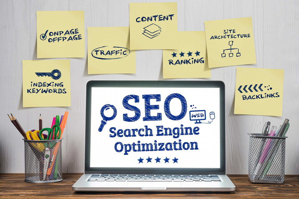 a laptop is open to a screen that says seo search engine optimization