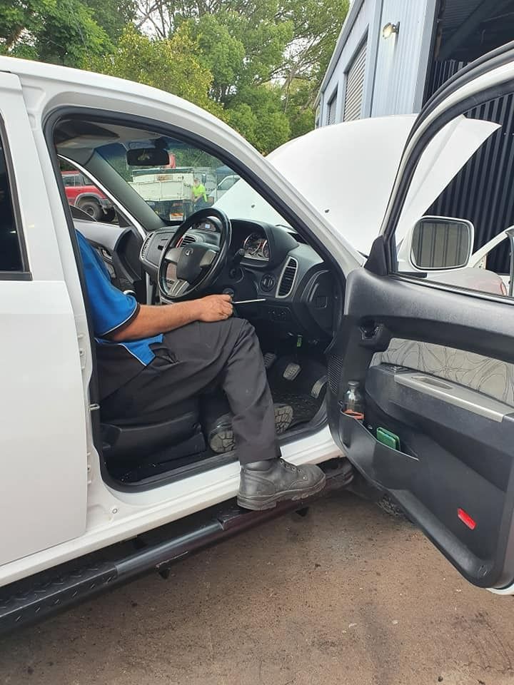 Person in a White Truck With the Hood Open — Adam's Automotive Centre in Nambour, QLD