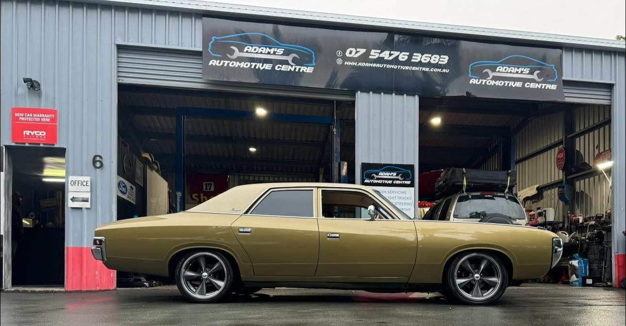 Gold classic car parked outside an auto shop. — Adam's Automotive Centre in Nambour, QLD