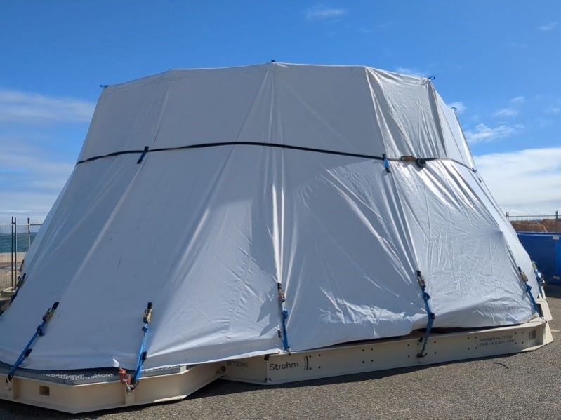 A large white tent is sitting on the ground