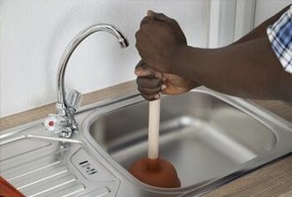 Plumber Cleaning Sink with Plunger — Clogs in Wichita, KS