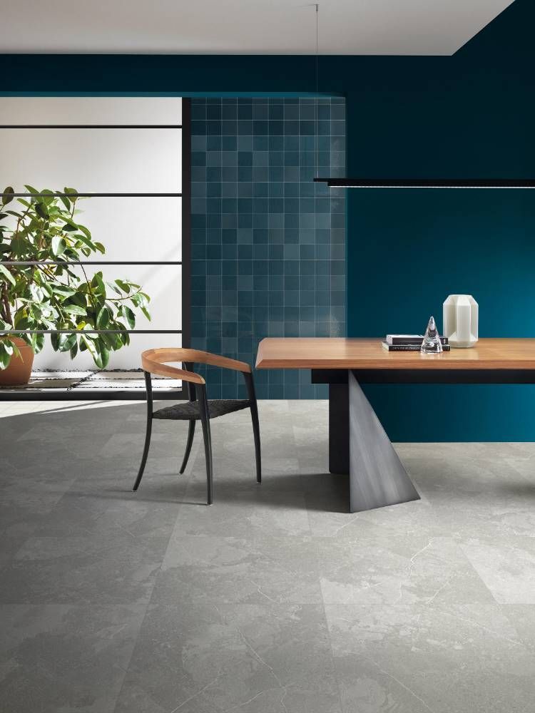 A Wooden Table and Chair in a Room With Blue Walls — Tileflair in Mitchell, ACT