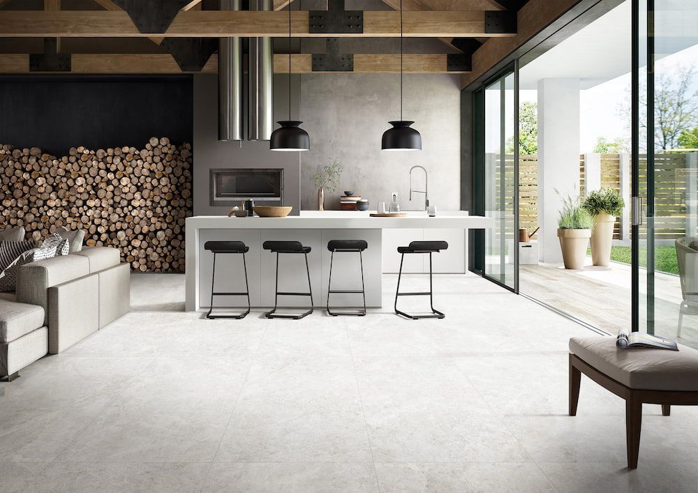 A Modern Kitchen With a Large Island and Stools — Tileflair in Mitchell, ACT