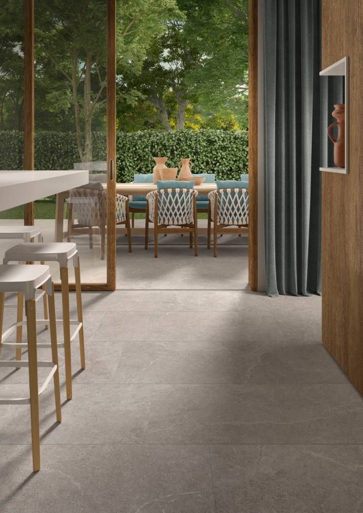 A Dining Room With a Table and Chairs and a Sliding Glass Door — Tileflair in Mitchell, ACT