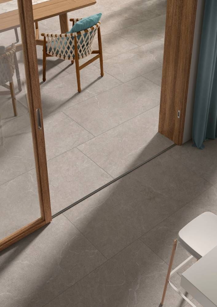 A Dining Room With a Table and Chairs and a Sliding Glass Door — Tileflair in Mitchell, ACT