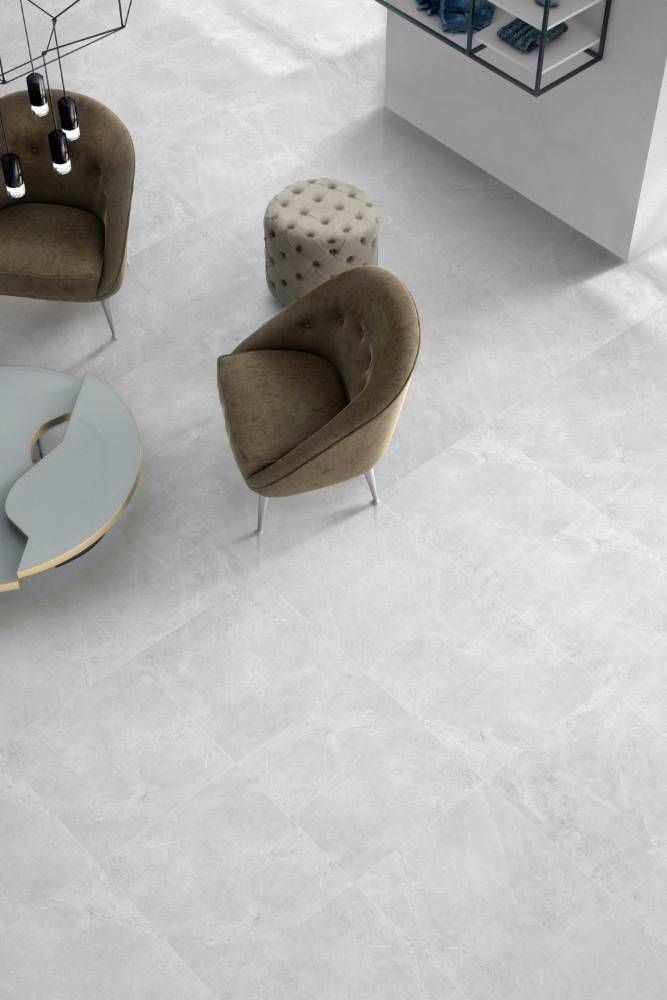 An Aerial View of a Living Room With Chairs and Ottomans — Tileflair in Mitchell, ACT