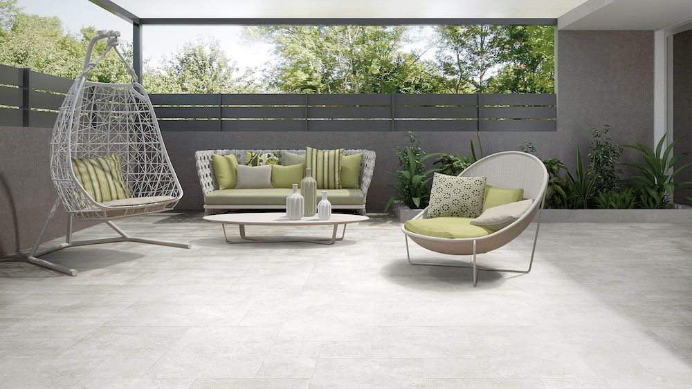 A Patio With a Couch, Chair, Table and Swing — Tileflair in Mitchell, ACT