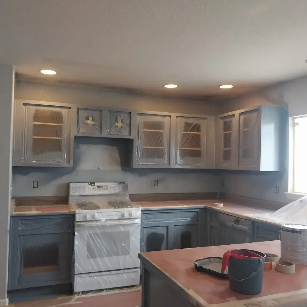 A kitchen with gray cabinets and a white stove