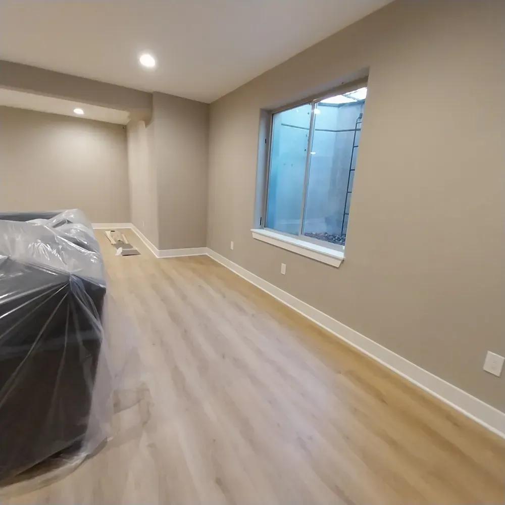 An empty room with a couch and a window