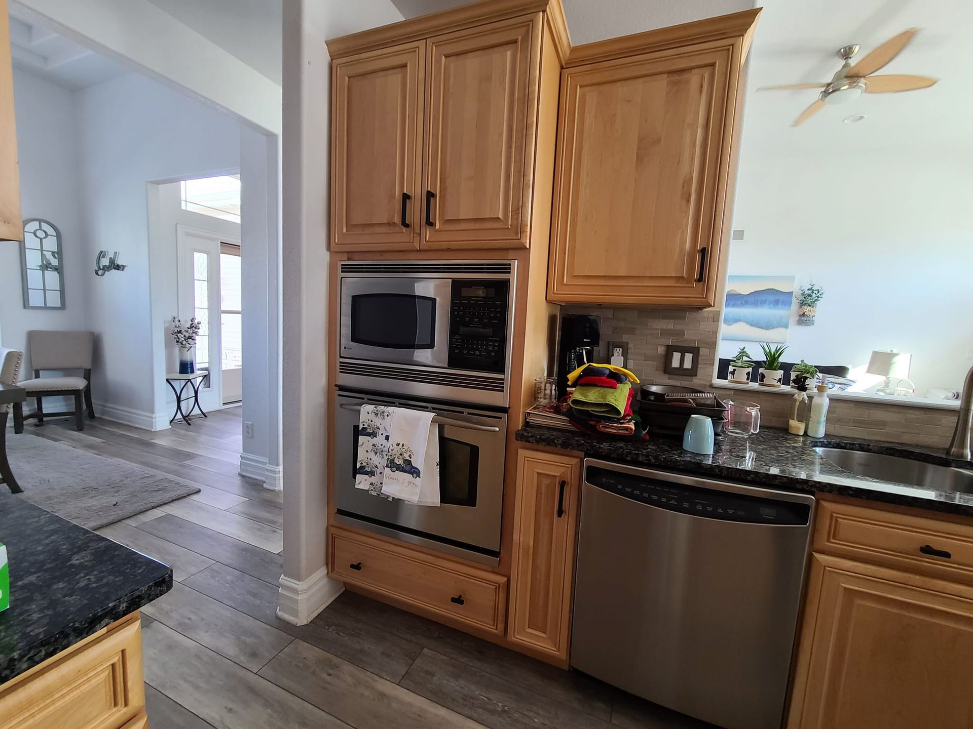 A kitchen with stainless steel appliances and wooden cabinets.