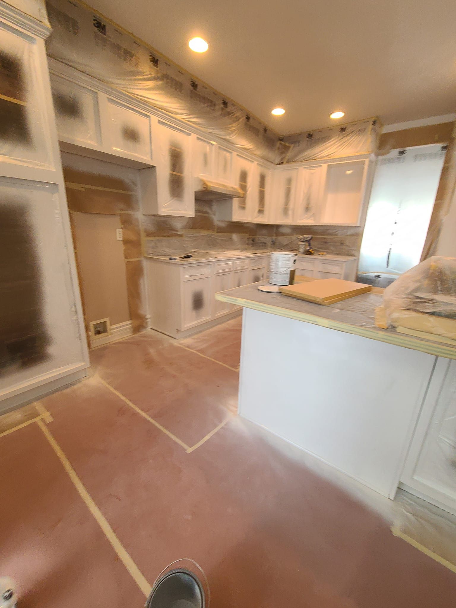 A kitchen is being painted in a house.