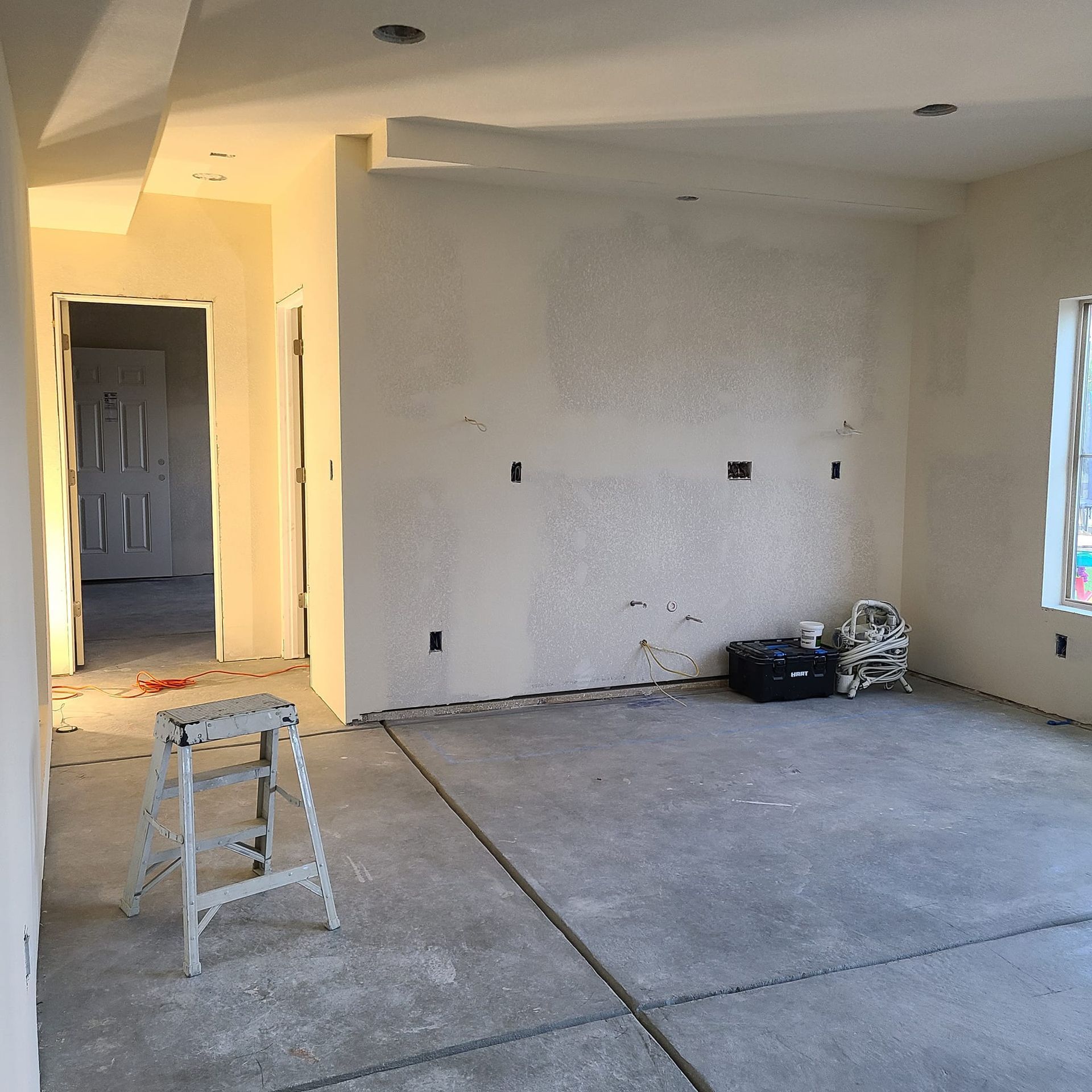 An empty room with a ladder on the floor