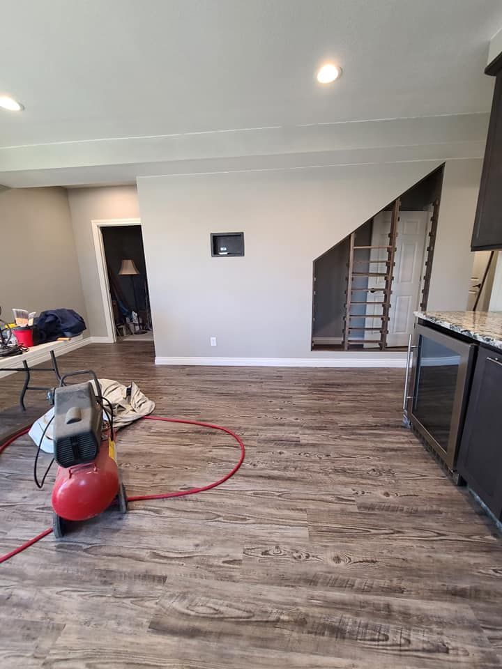 There is a red air compressor in the middle of the room.