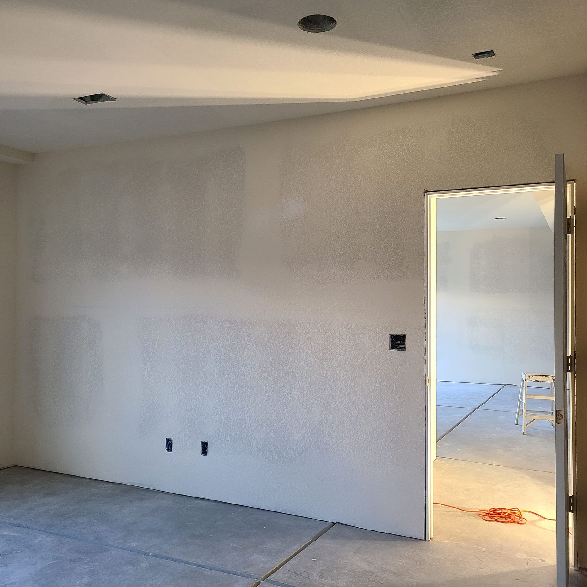 A room with white walls and a door that is open