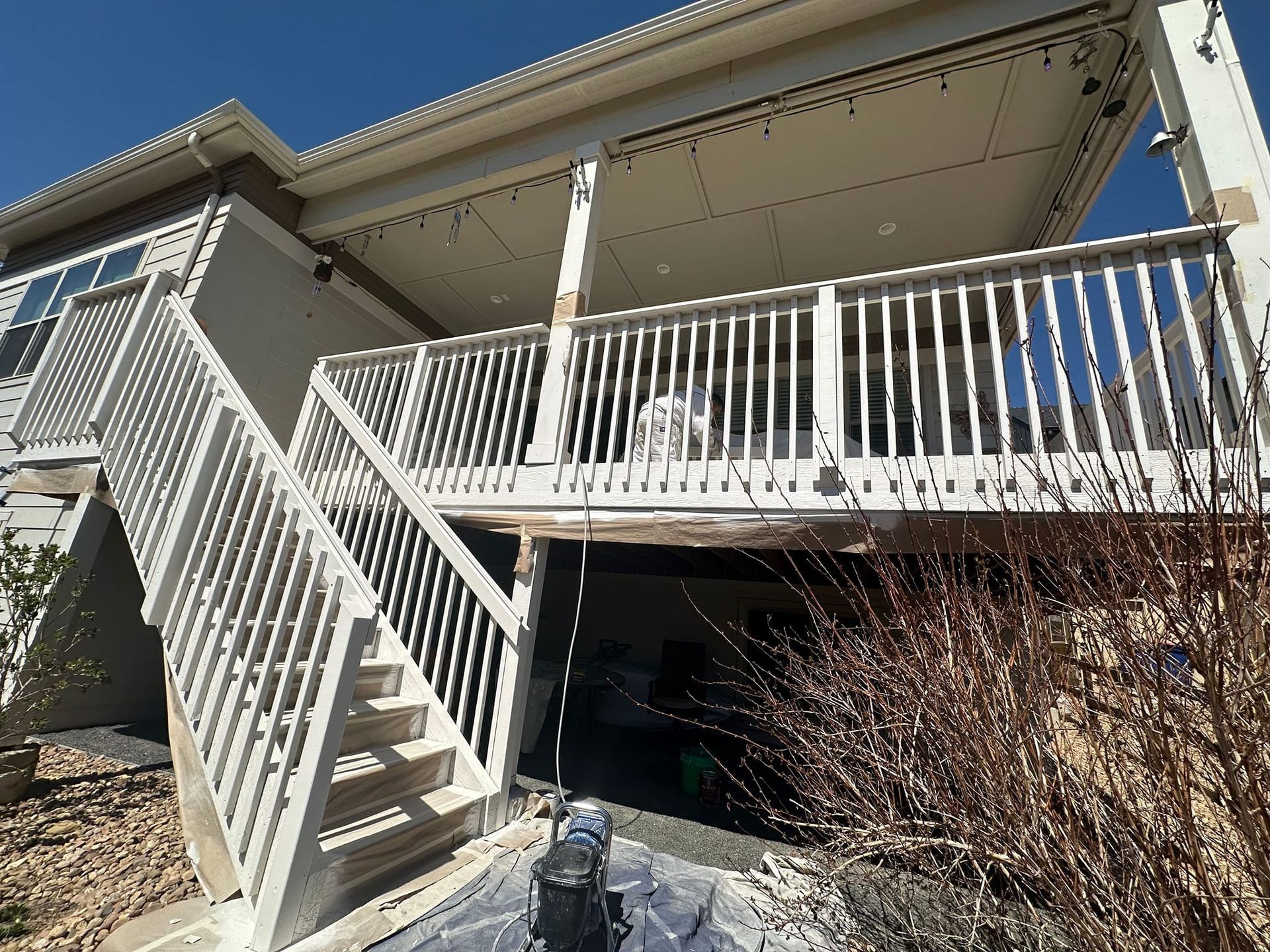 A house with a large deck and stairs leading up to it.