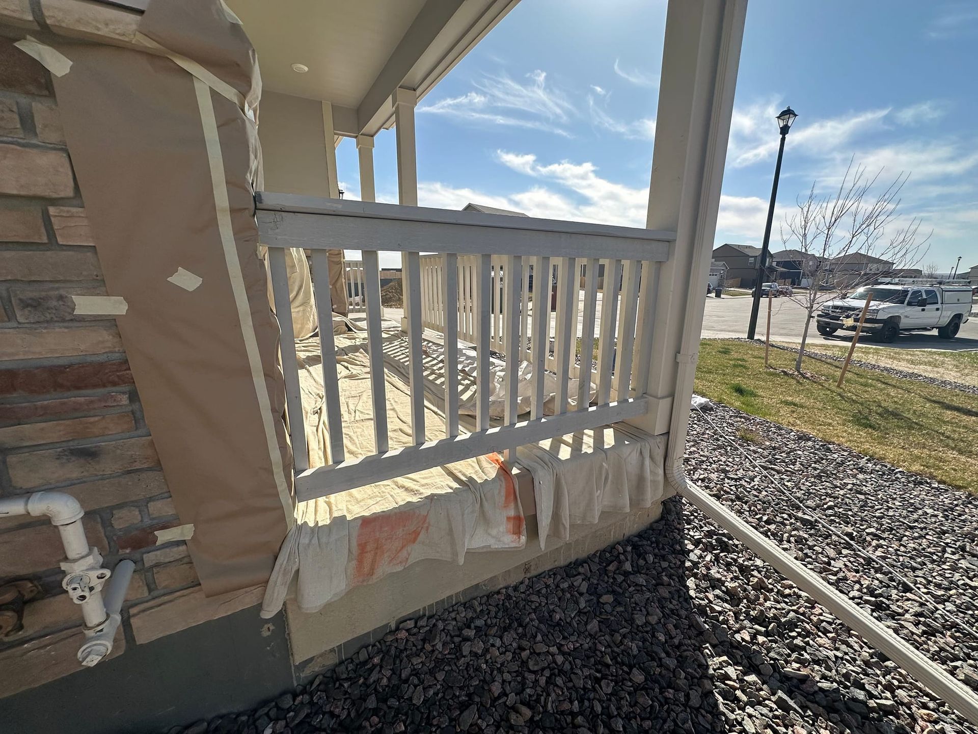 A broken railing on a porch of a house.