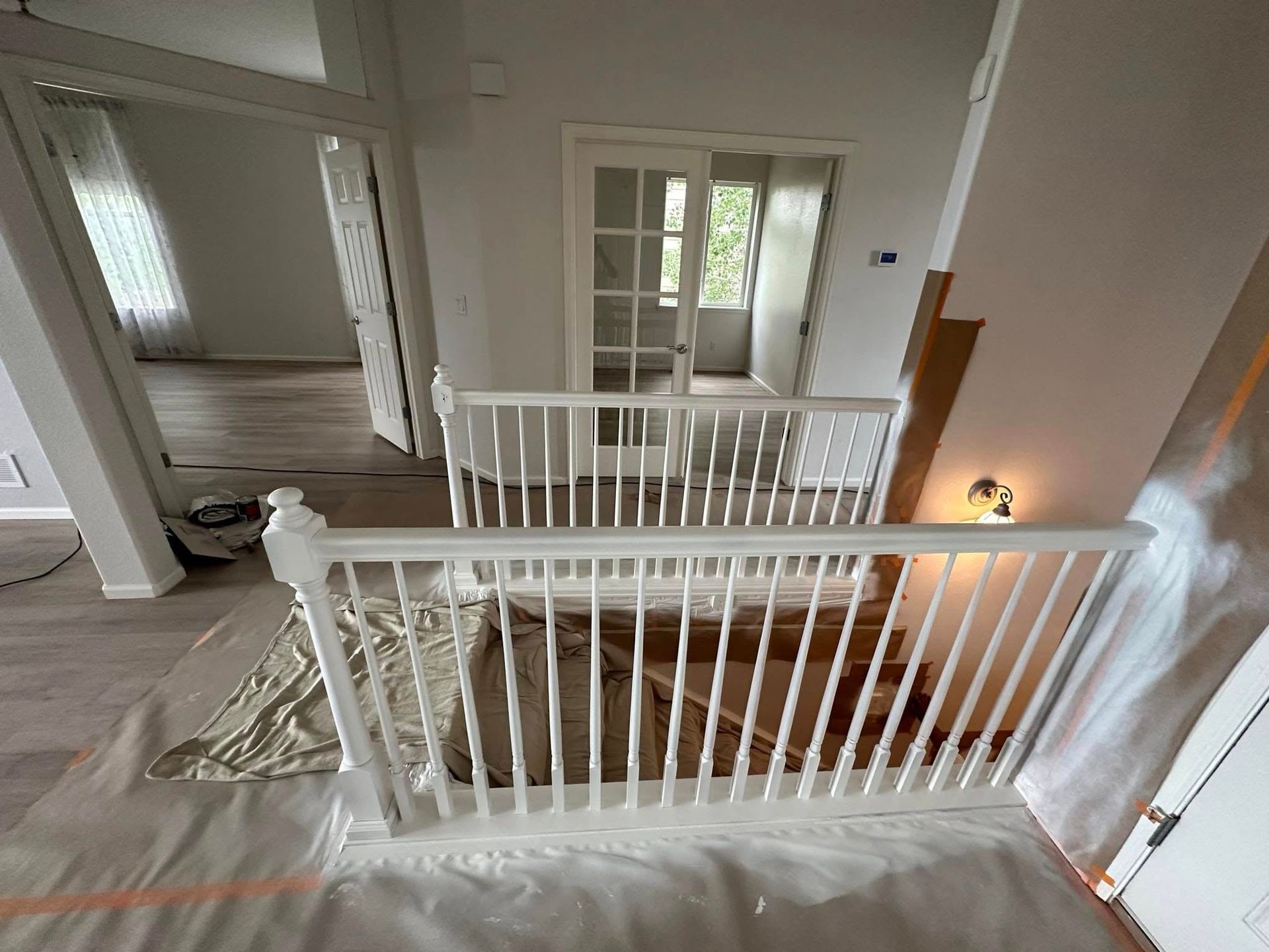 There is a staircase with a railing in the middle of the room.