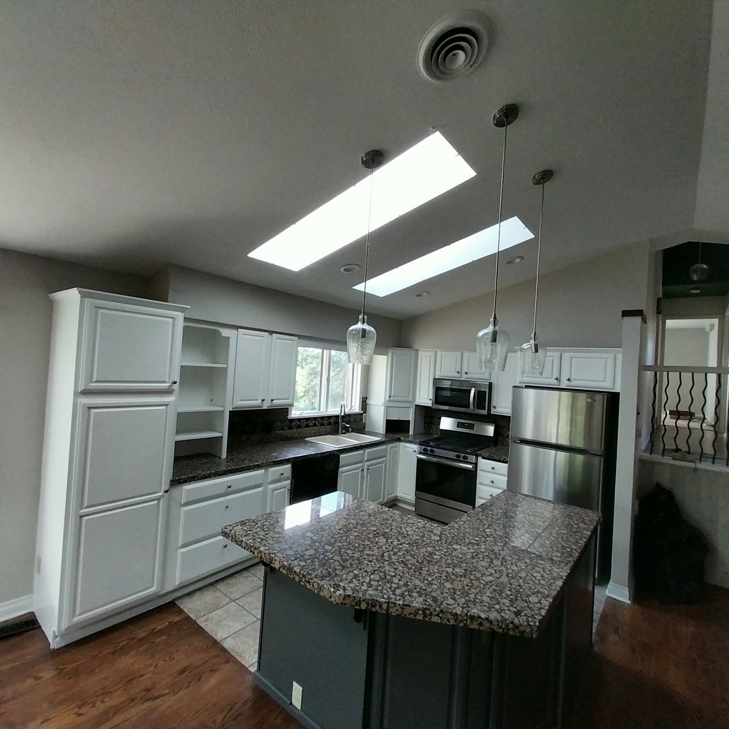A kitchen with stainless steel appliances and granite counter tops