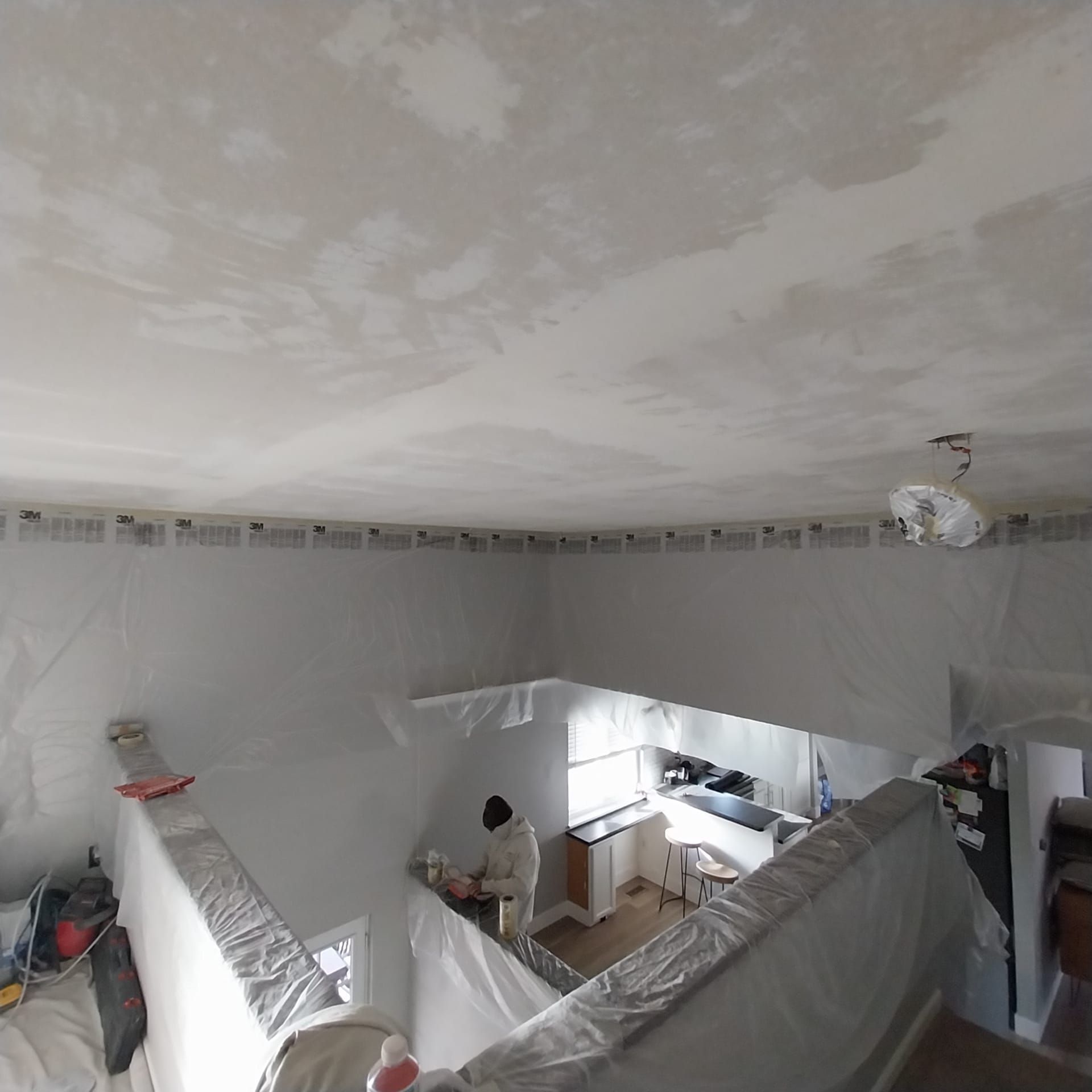 A room with a couch and a fan on the ceiling