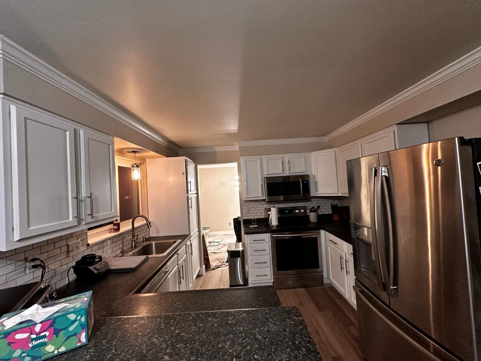 A kitchen with stainless steel appliances and granite counter tops