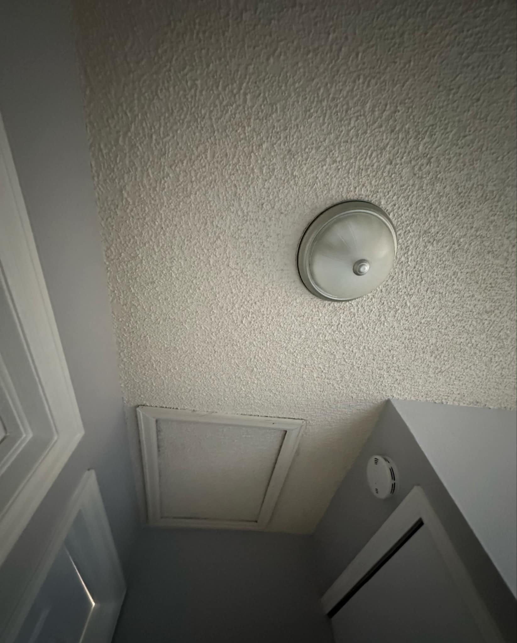 A ceiling light is hanging from the ceiling of a room.