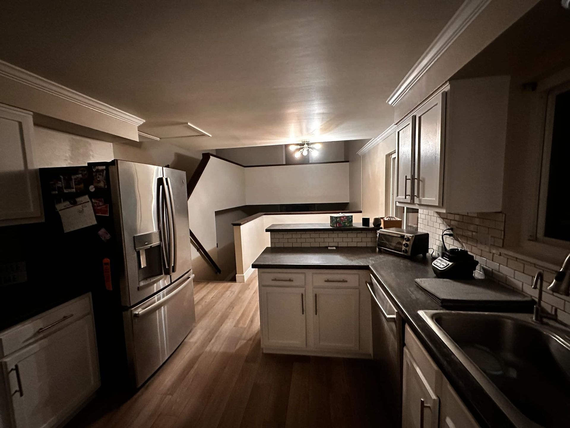 A kitchen with stainless steel appliances and white cabinets