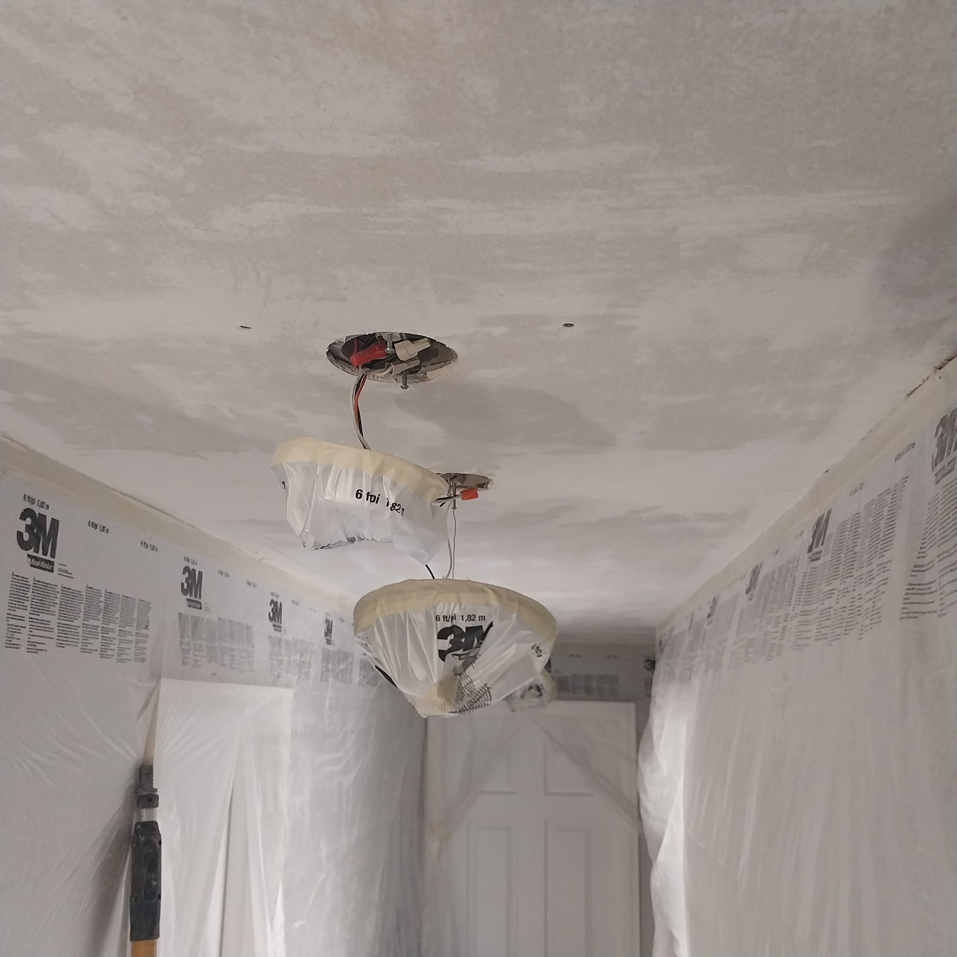 A hallway with a ceiling that has 3m tape on it