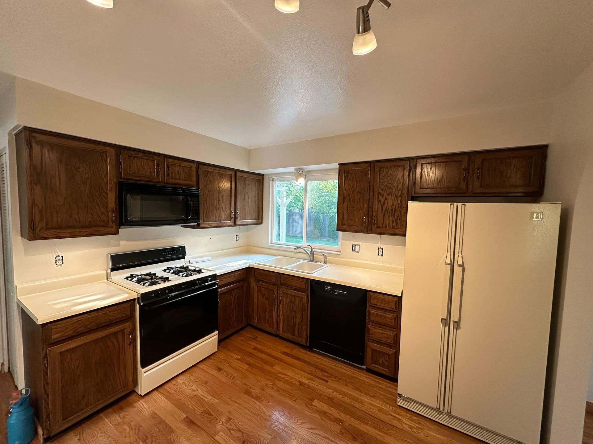 A kitchen with a stove , refrigerator , dishwasher , and microwave.