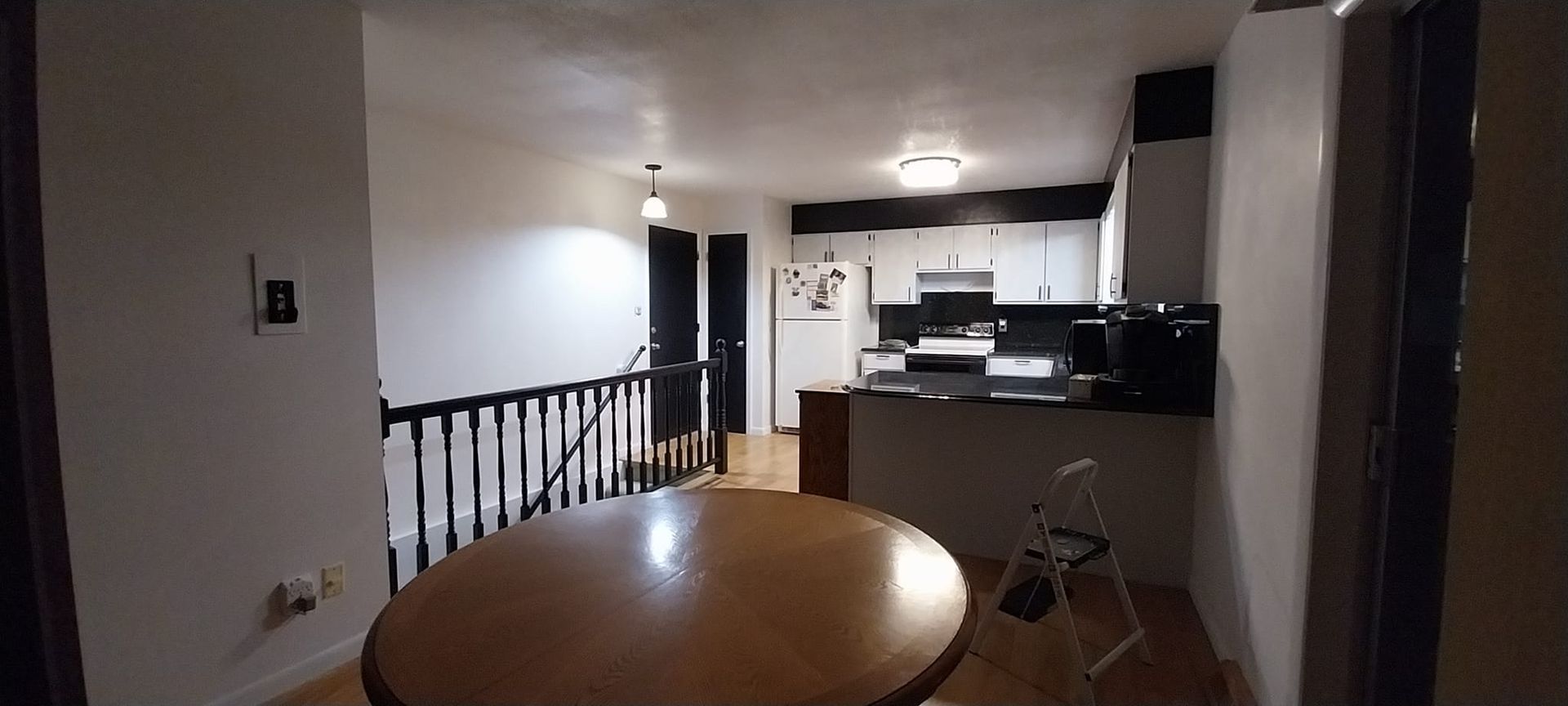 A kitchen with a table and chairs in the middle of it.
