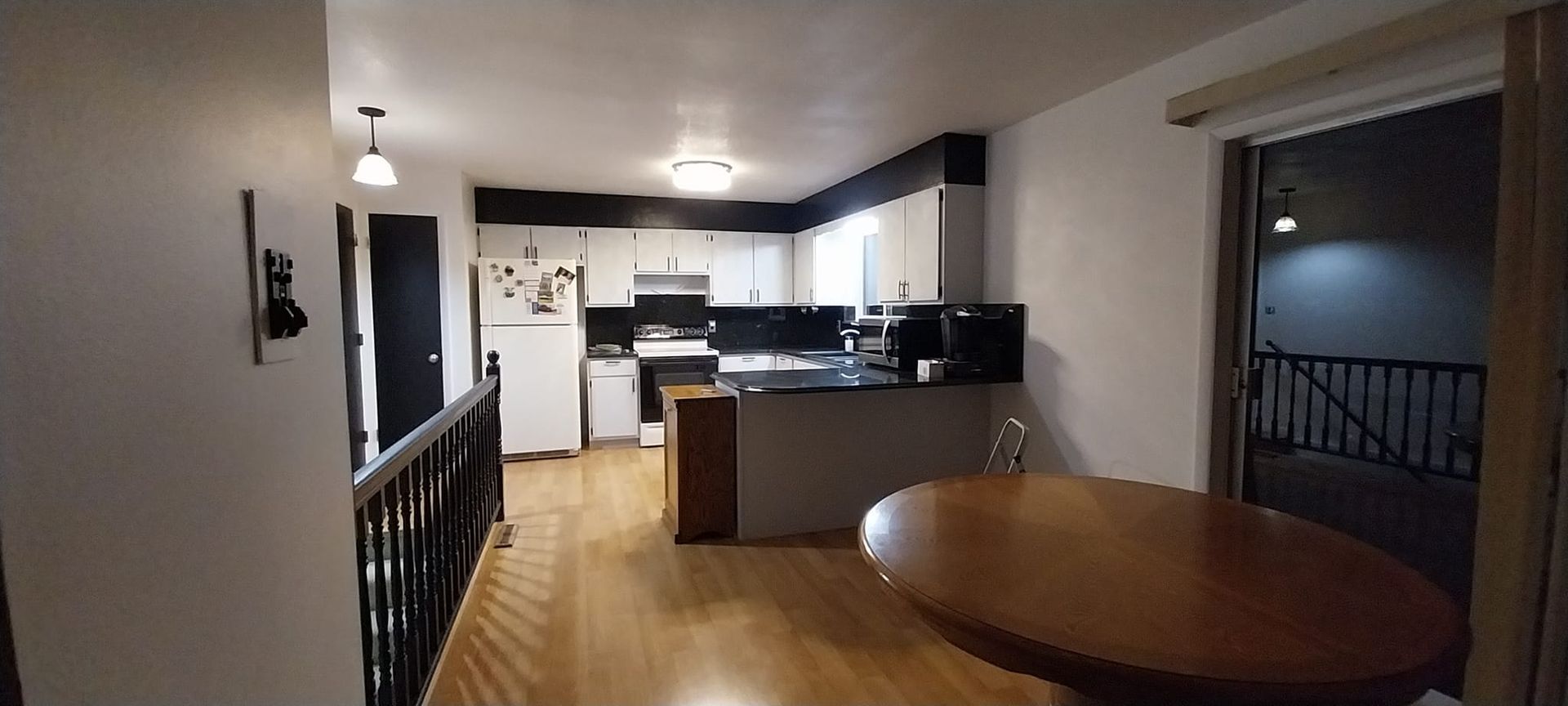 A kitchen with a table in the middle of it