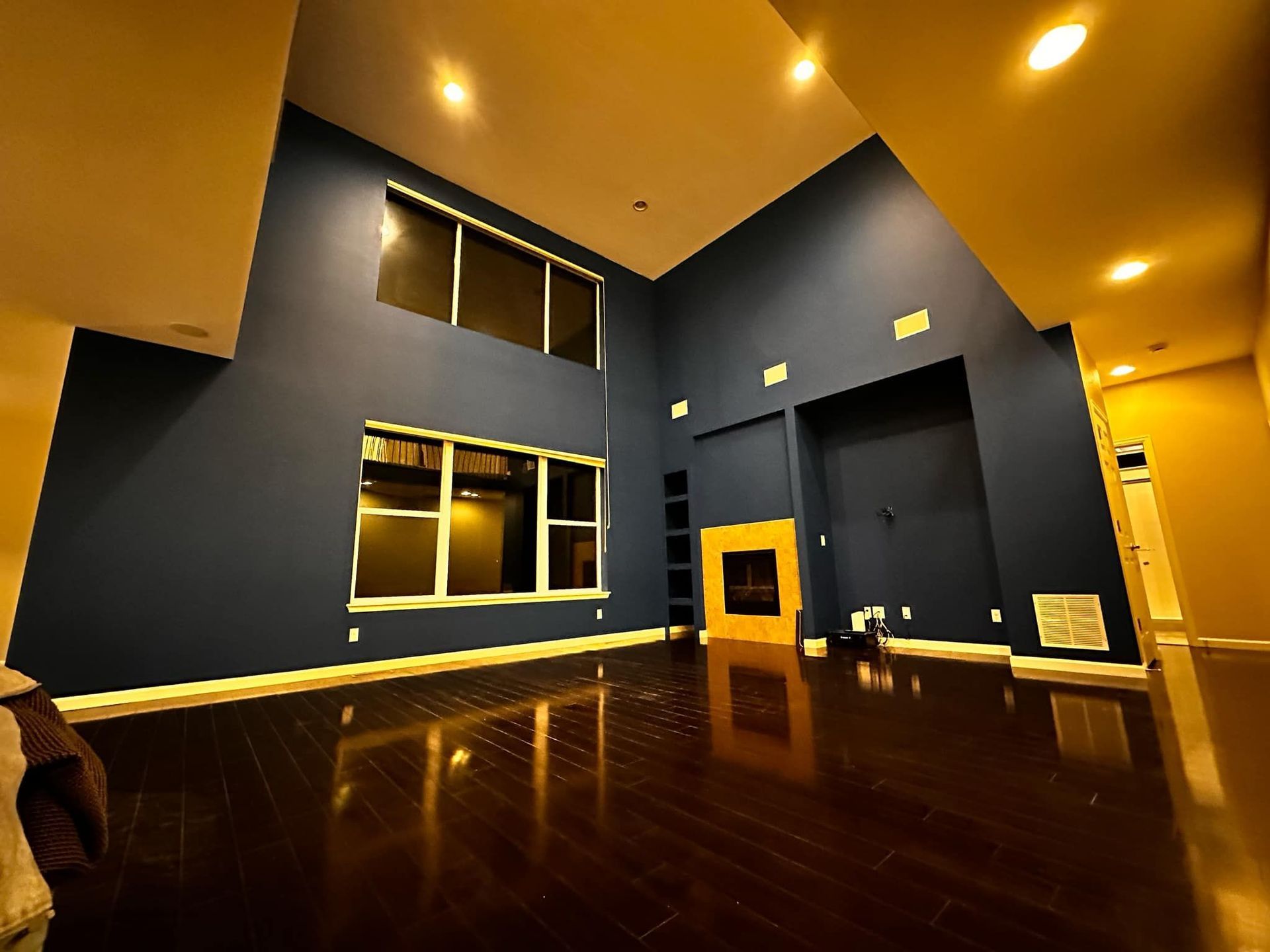 A living room with blue walls and a fireplace