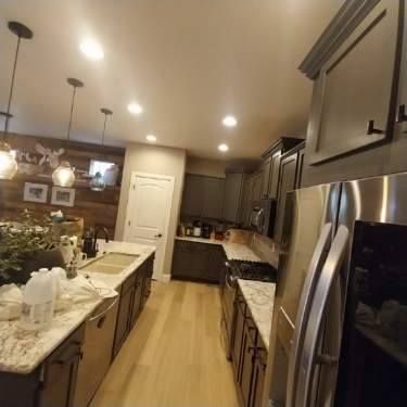 A kitchen with stainless steel appliances and granite counter tops.