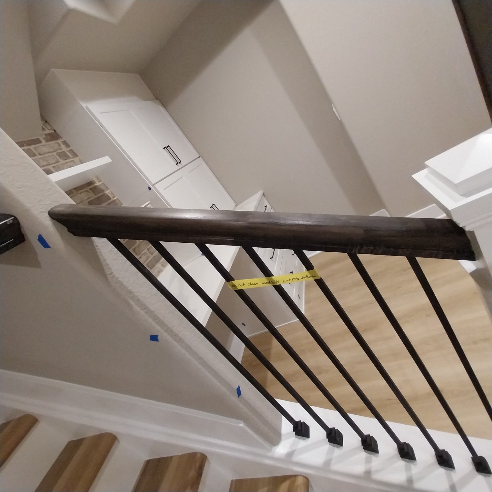 A staircase with a black railing and wooden steps