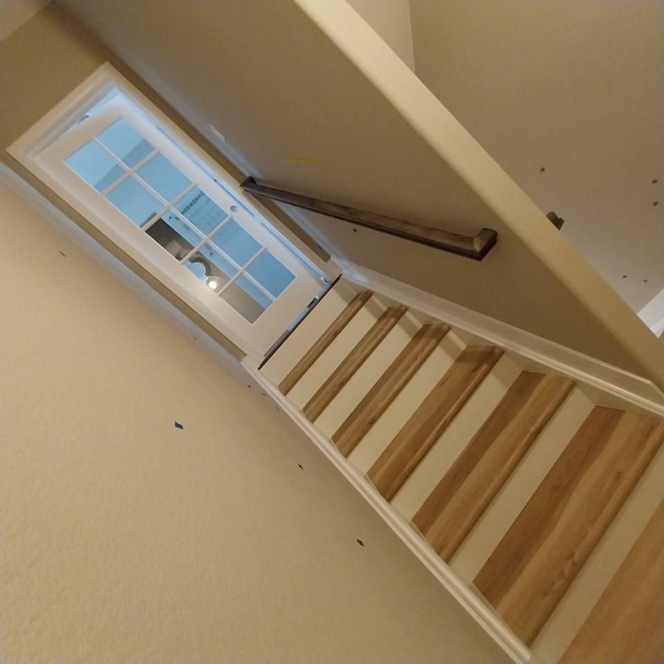 A staircase with wooden steps and a white railing