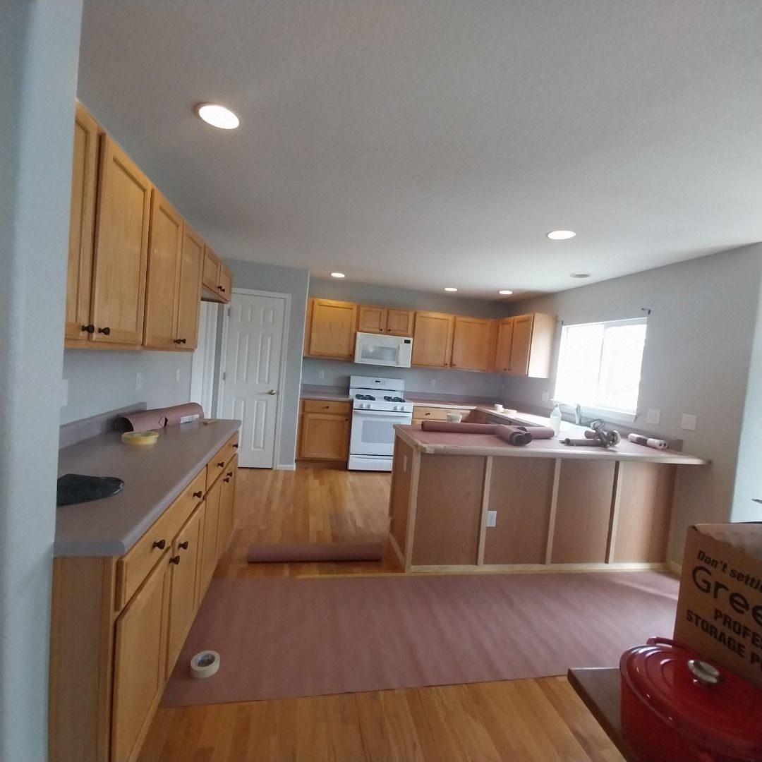 A kitchen with wooden cabinets and a stove top oven