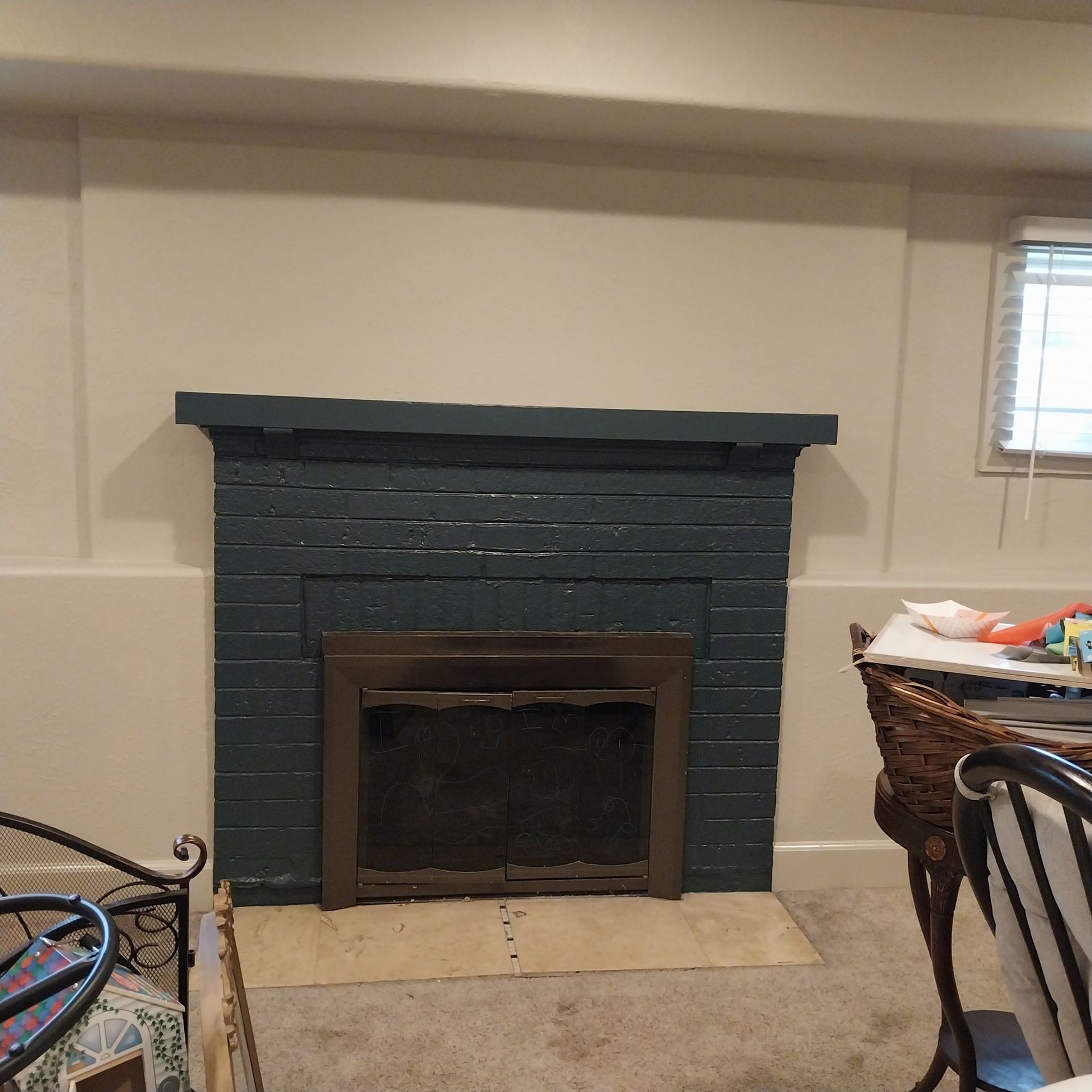 A living room with a blue brick fireplace