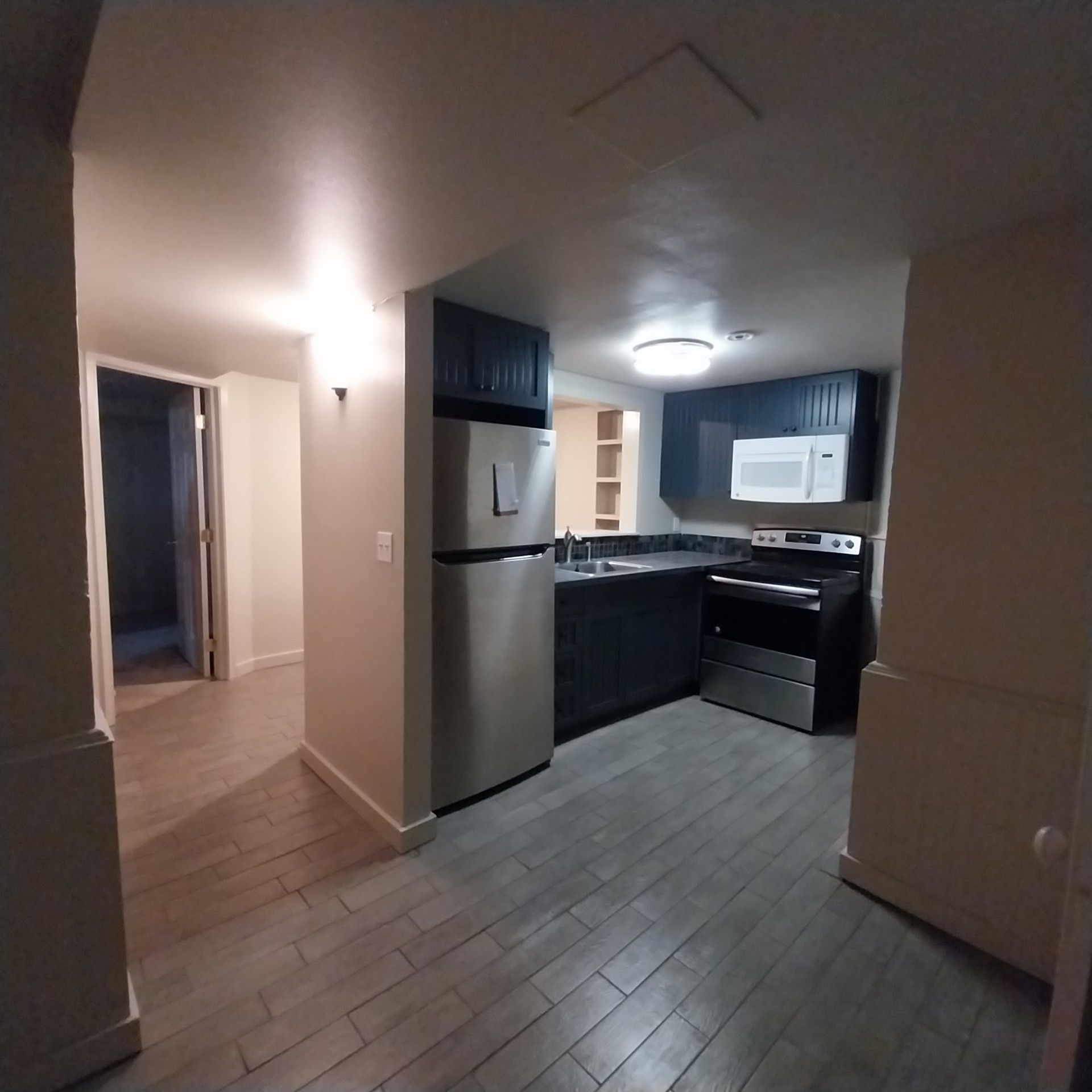 A kitchen with stainless steel appliances including a refrigerator