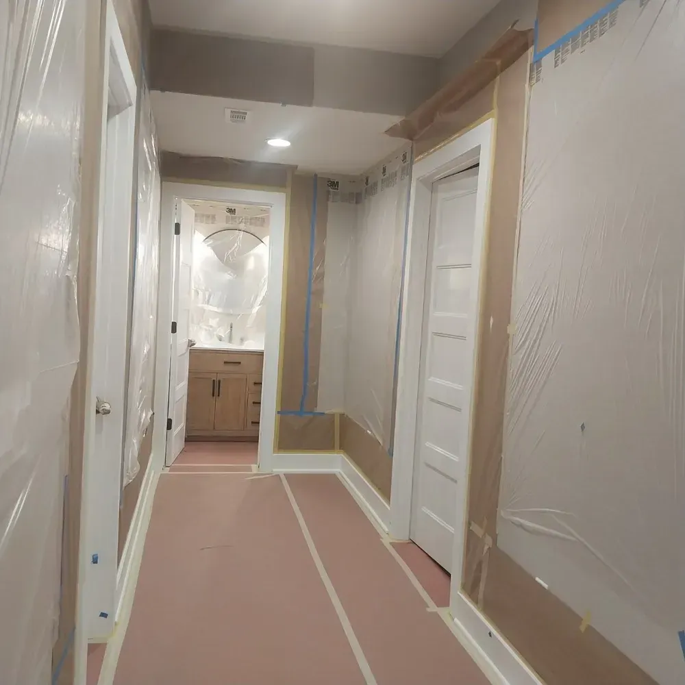 A hallway in a house that is being painted.
