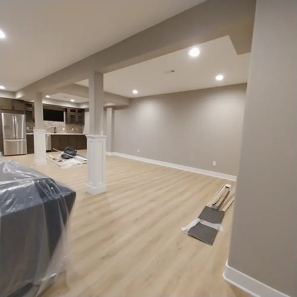 A room with a couch and a refrigerator in it