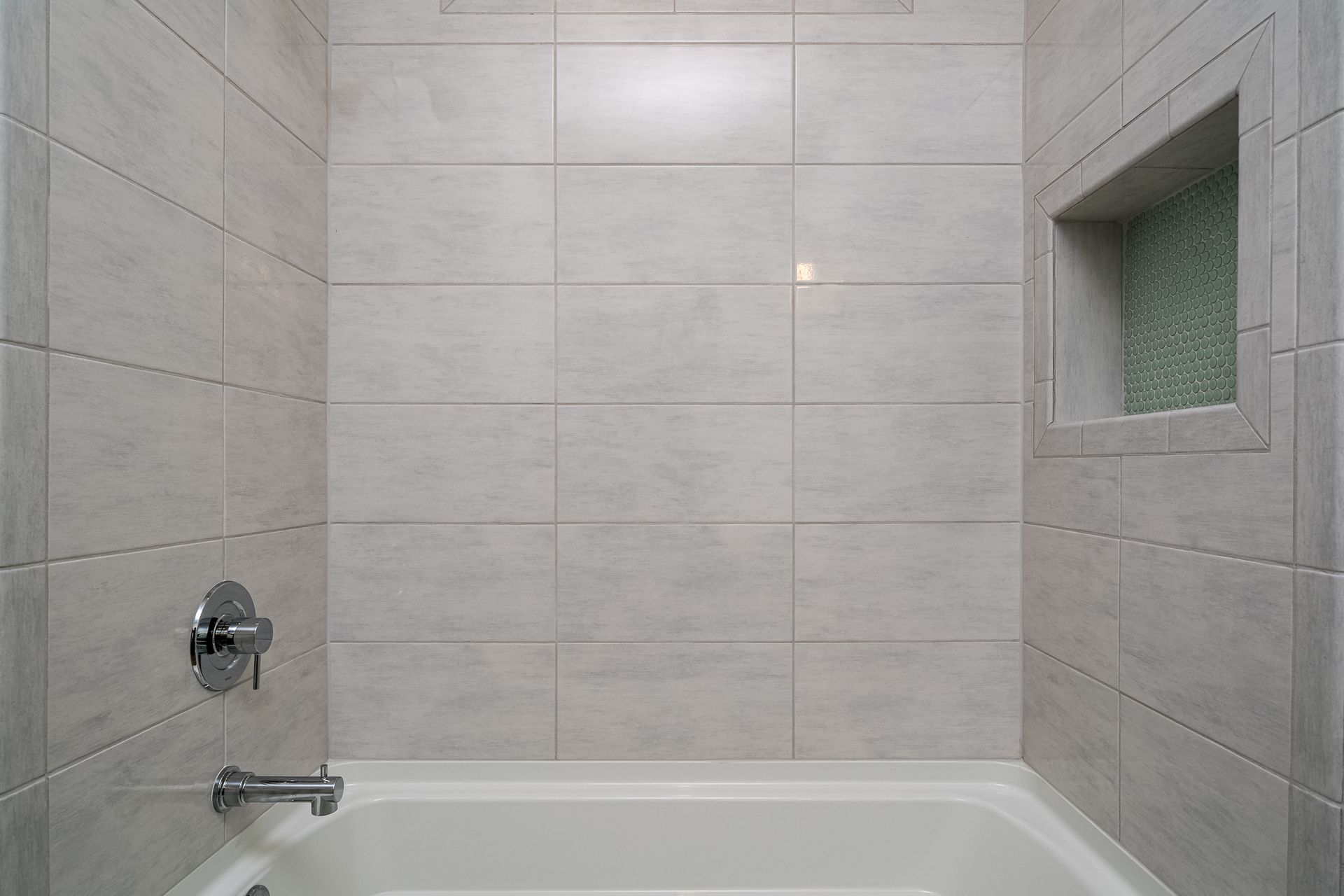 A bathroom with a bathtub and a shower.