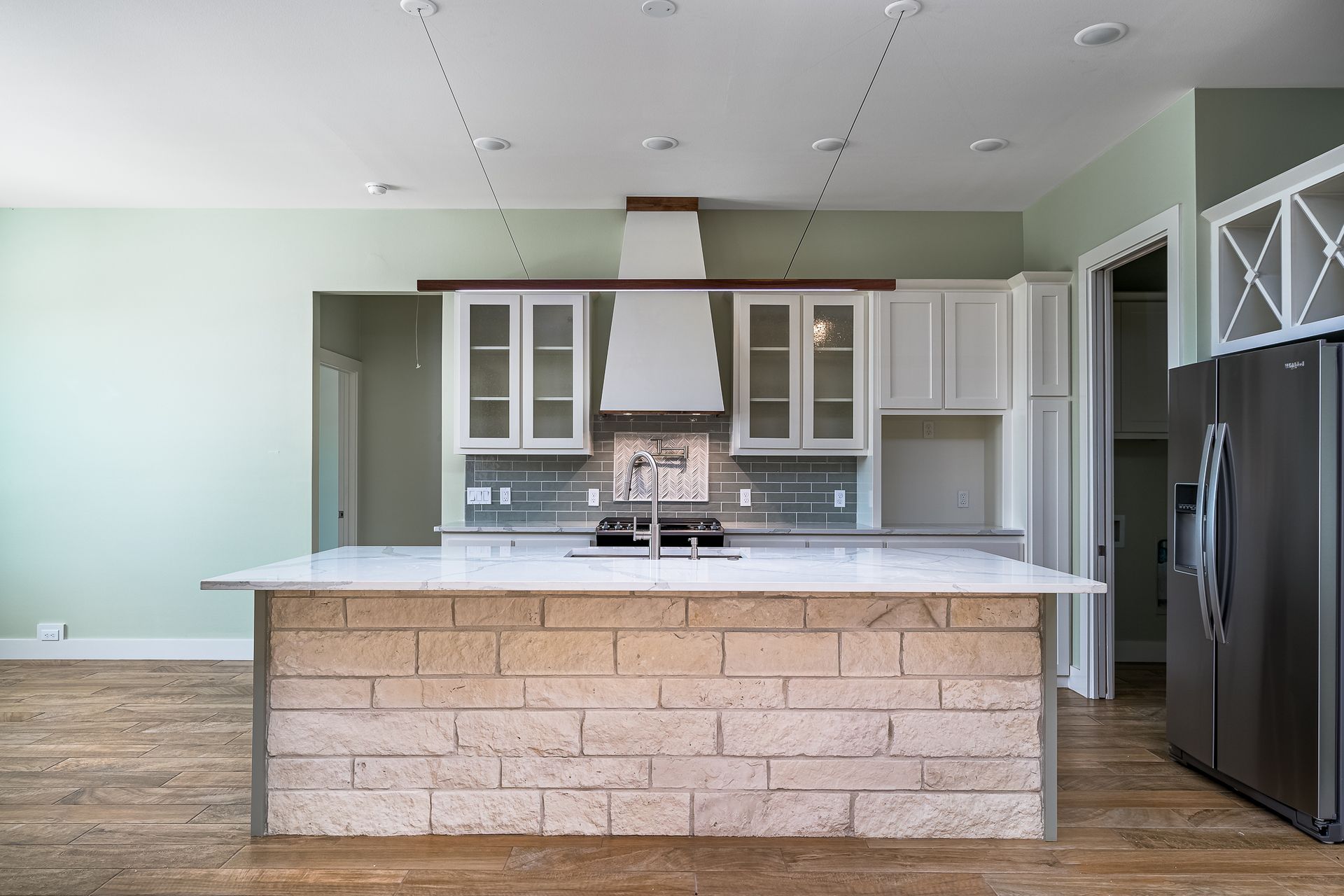 A kitchen with a large island in the middle of it